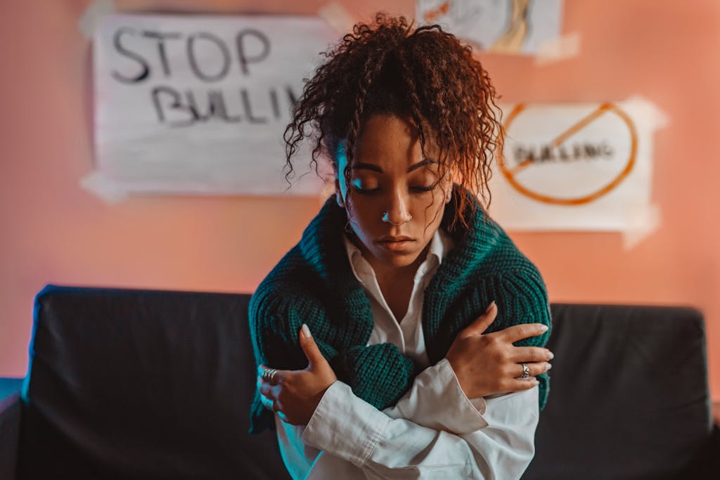 A Woman in a White Log Sleeves and Green Sweater. The Social and emotional mindset is portrayed